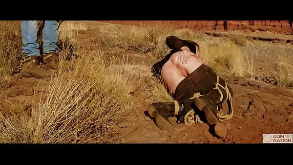 Big-ass blonde gets her asshole whipped, then gets rough anal sex in dirt and piss -- a real BDSM session outdoors in the Western USA with Rebel Rhyder